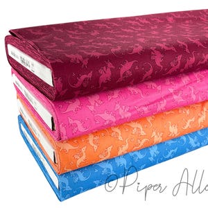 May include: Four stacks of fabric with a repeating pattern of pink dinosaurs on a white background. The fabric is in four colors: burgundy, pink, orange, and blue.