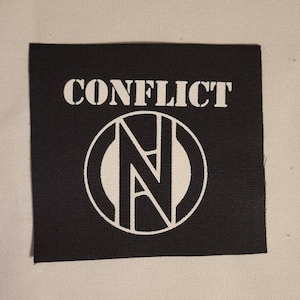 May include: Black and white embroidered patch with the word "CONFLICT" and a stylized "N" inside a circle.