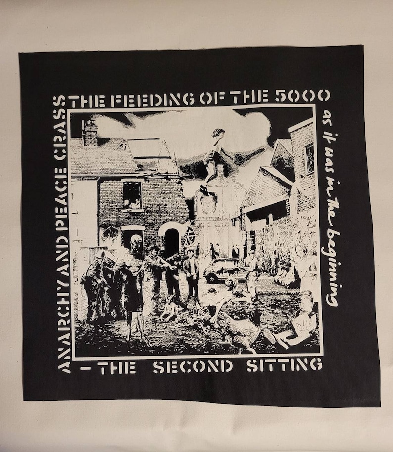 May include: Black and white patch with the text "Anarchy and Peace Crass - The Feeding of the 5000 - The Second Sitting as it was in the beginning". The patch features a black and white image of a street scene with people and buildings.