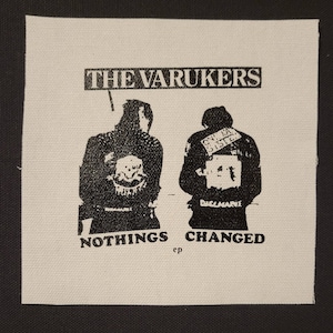 May include: Black and white image of two people wearing jackets with patches. The text "THE VARUKERS" is at the top of the image. The text "NOTHINGS CHANGED ep" is at the bottom of the image.