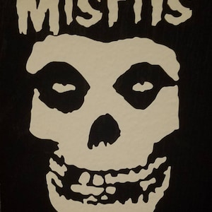 May include: Black and white graphic of a skull with the word "MISFITS" above it.