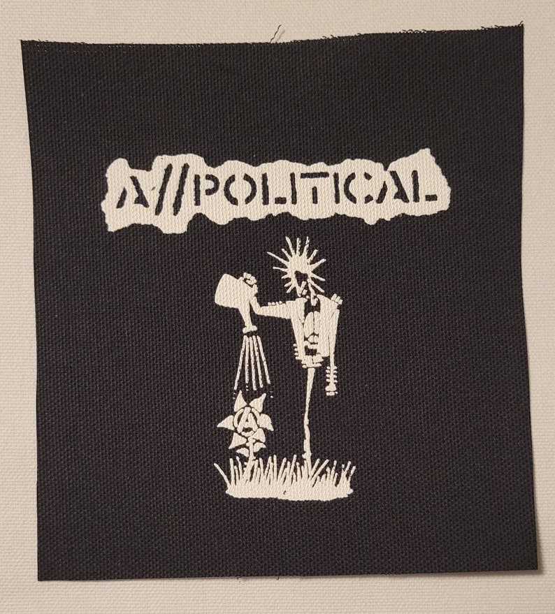 May include: A black and white patch with the text "A//POLITICAL" and a graphic of a stick figure watering a flower with an anarchy symbol.