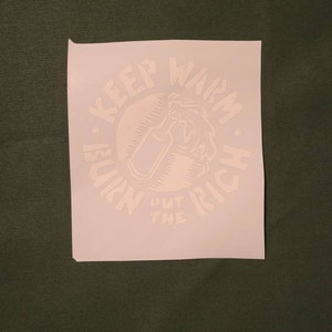 May include: White vinyl sticker with a circle design. The circle has the text "Keep Warm. Burn Out The Rich." inside of it. There is a drawing of a hand holding a bottle with a flame coming out of the top.