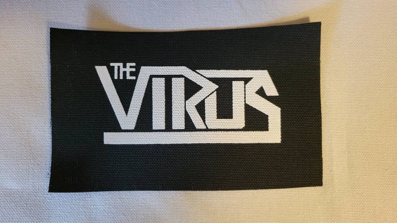 May include: A black fabric patch with white text that reads "THE VIRUS" in a bold, stylized font.