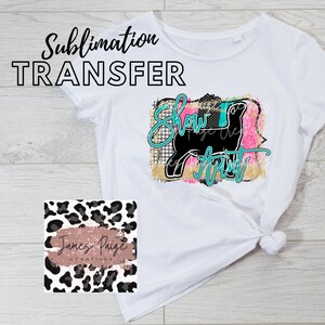 May include: White t-shirt with a sublimation transfer design featuring a black silhouette of a show animal with the text "Show Aunt" in turquoise and black lettering. The design is surrounded by pink, gold, and black abstract shapes.