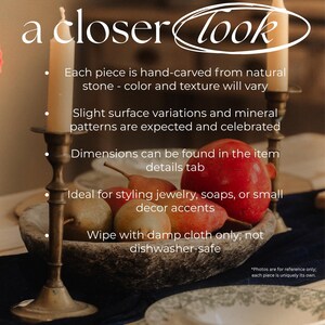 May include: A still-life image featuring a stone bowl filled with pears and a pomegranate, flanked by two lit candles in brass candlesticks. The text "a closer look" is at the top. The image suggests home decor.