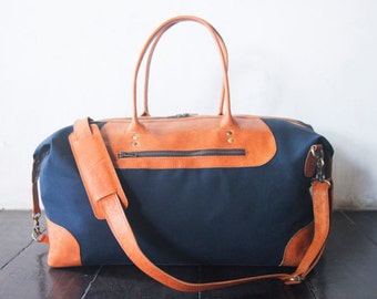 Waxed canvas and leather weekend and travel bag for men and women. Handmade carry on duffel and travel bag. Anniversary gift in navy blue