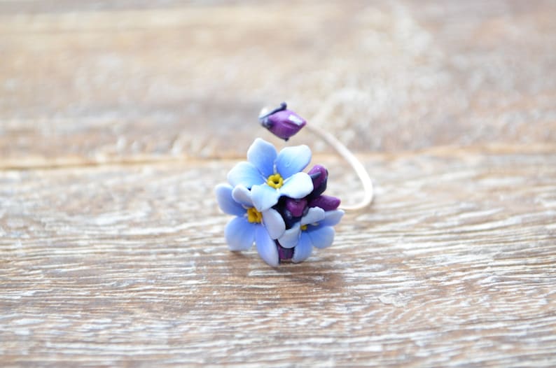 Delicate blue forget me not flowers on a sterling silver ring base Minimal design