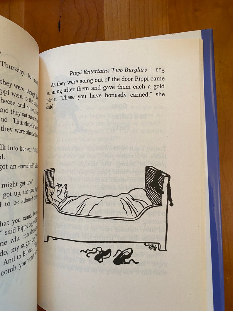 May include: A black and white illustration of a person in bed with two shoes on the floor. The text in the image reads "Pippi Entertains Two Burglars | 115".  "As they were going out of the door Pippi came running after them and gave them each a gold piece. "These you have honestly earned," she said."