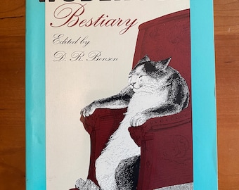 May include: A blue book with the title "A Wodehouse Bestiary" in white text. The book features a black and white illustration of a cat sitting in a red armchair.