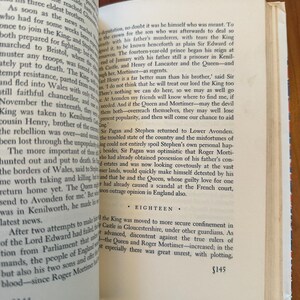 May include: Open book with text on aged paper. The pages are yellowed, and the text is in a serif font. The book is open to two facing pages, with the text of chapter eighteen visible. The page numbers are visible at the bottom of the pages.