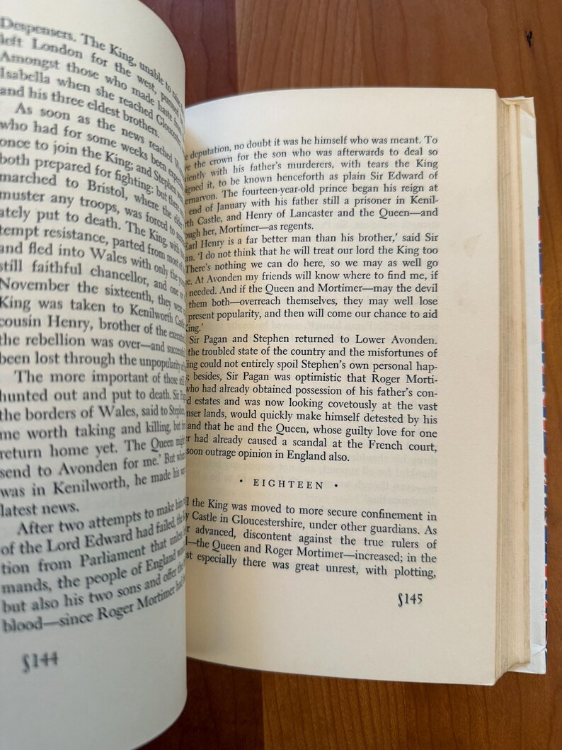 May include: Open book with text on aged paper. The pages are yellowed, and the text is in a serif font. The book is open to two facing pages, with the text of chapter eighteen visible. The page numbers are visible at the bottom of the pages.