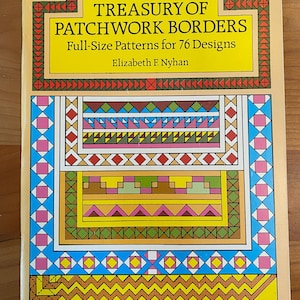 May include: A book titled "Treasury of Patchwork Borders" by Elizabeth F. Nyhan. The book cover features a colorful patchwork design with geometric shapes and patterns in shades of pink, blue, yellow, green, and orange.
