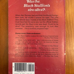 May include: The back cover of a paperback book titled "Was the Black Stallion's sire alive?"  The book cover is red with white text. The book is about a fictional horse and includes quotes from reviewers.
