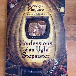 May include: Book cover with an illustration of a carriage with a pumpkin-shaped body. The title is "Confessions of an Ugly Stepsister" by Gregory Maguire, author of "Wicked".