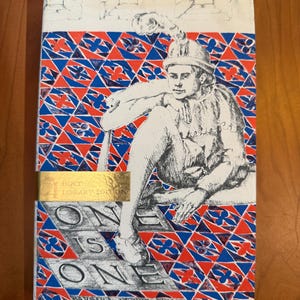 May include: A vintage hardcover book, "One is One" by Barbara Leonie Picard. The cover displays a detailed illustration of a person in historical clothing, set against a geometric pattern of red, blue, and white. The book has a gold label that reads "Holt Library Edition."