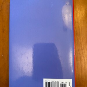May include: The back cover of a blue hardcover book with a barcode and ISBN number: 978-0-470-55745-5. The book has a red spine with the word "EAN" printed on it.