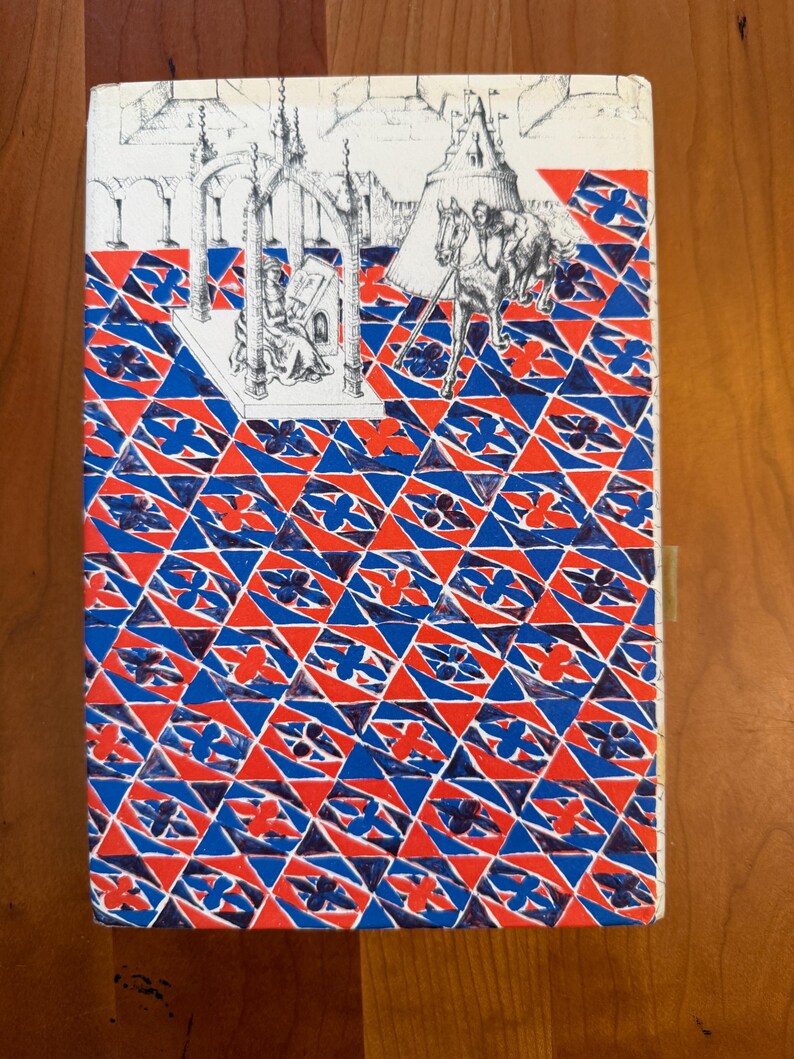 May include: Book cover with a geometric pattern in red, white, and blue. The top features a black and white illustration of a medieval scene with figures and architecture. A tan bookmark is attached.