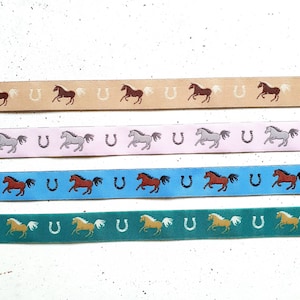 16 mm wide woven ribbon galloping horses horseshoes in beige-light brown, pink, blue and emerald green each design is delivered in one piece image 1