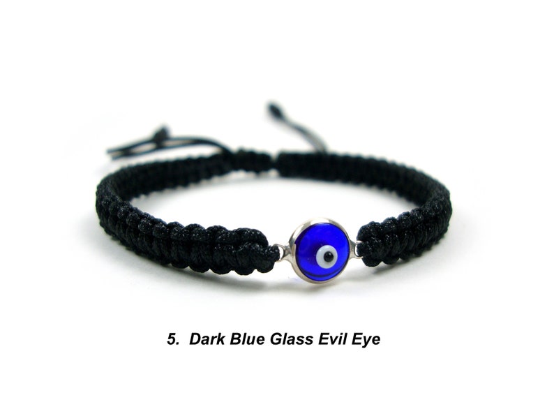 May include: Black braided bracelet with a dark blue glass evil eye charm.