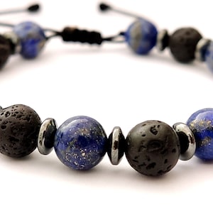 May include: A beaded bracelet with blue and black beads. The bracelet is made with lapis lazuli, lava rock, and hematite beads.
