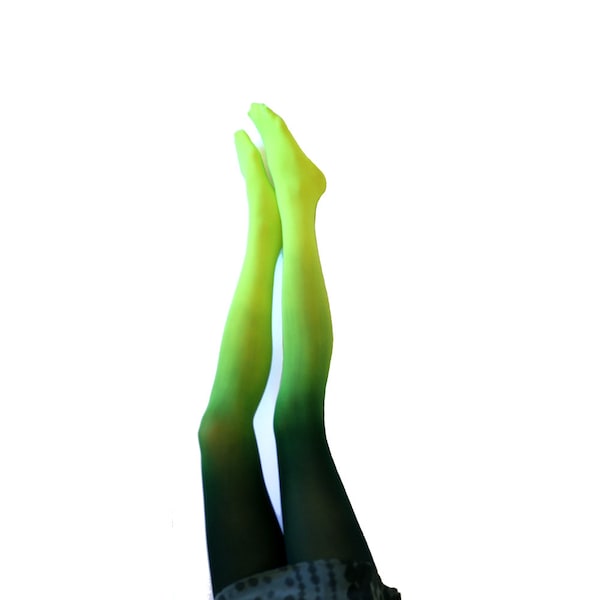 May include: A pair of green ombre tights with a darker green shade at the bottom. The tights are worn on a person's legs, with the feet not visible in the image.