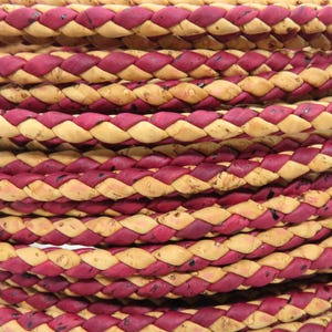 May include: Close-up of a braided rope with alternating burgundy and tan sections. The rope is tightly woven, creating a textured surface. The colour combination gives the rope a rustic appearance, suitable for various craft projects.