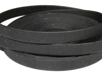 May include: Black cork trim, a flat, flexible, and durable material, is shown in a coiled stack. The trim is made of natural cork and has a smooth, matte finish.
