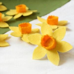Yellow felt daffodils with orange felt centres for attaching to dog collars