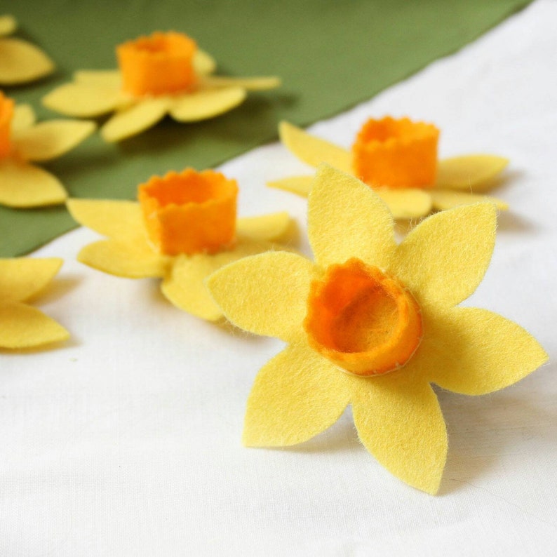 Yellow felt daffodils with orange felt centres for attaching to dog collars