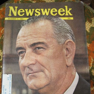 May include: A vintage Newsweek magazine cover featuring a black and white photo of President Lyndon B. Johnson. The cover text reads "Newsweek" in yellow letters and "December 9, 1963" in black letters. The price is listed as "25c".
