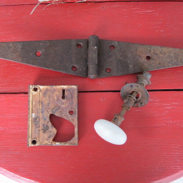 Antique white ceramic doorknob; door hinge, lock plate. Vintage farmhouse, farm salvage. Rusty Rustic farmstead; steampunk. Large Iron hinge