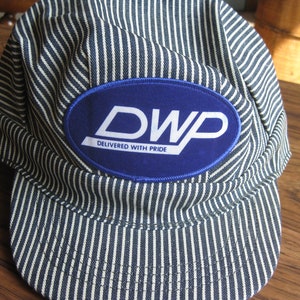 Vintage Railroad Engineer cap. classic hat, DWP logo patch; Duluth Winnipeg & Pacific "Delivered With Pride". Made in USA; Adjustable back