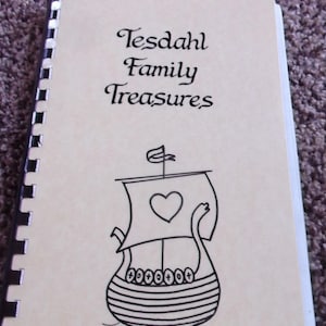 May include: A white ceramic mug with a black handle and the text "But First, Coffee" in a bold, black font. The mug is sitting on a wooden surface. The mug is approximately 4 inches tall.