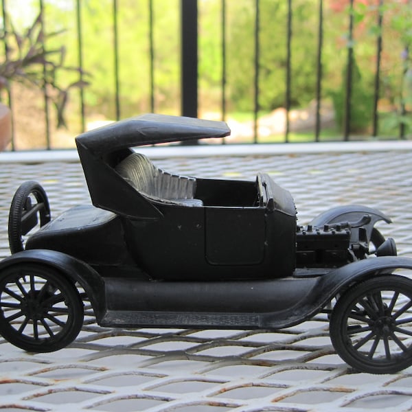 Vintage 1925 Ford Model T model car; made from kit; completed automobile; black plastic. Tires rotate. 5 1/4" L; 3" W; 2 1/2" H. Display car