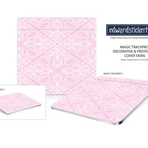 May include: Pink decorative cover skins for the Magic Trackpad. The skins feature a white damask pattern on a pink background. The image shows two Magic Trackpads with the skins applied, one in a close-up view and the other in a full view.
