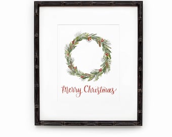 May include: A framed print with a watercolor illustration of a Christmas wreath with pine branches, berries, and pine cones. The text "Merry Christmas" is written in cursive below the wreath.
