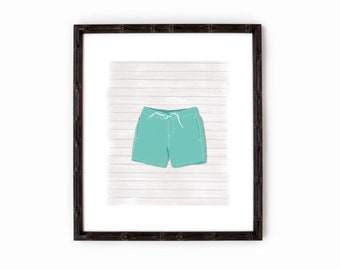 May include: A framed illustration of a pair of teal blue swim trunks with a white drawstring on a white wood background.
