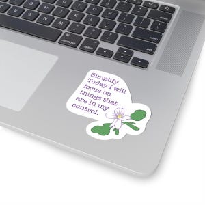 May include: A white sticker with a purple flower and text that reads "Simplify. Today I will focus on things that are in my control."