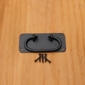 May include: Black metal door handle with a rectangular base and a curved handle. The handle has a knot on each end. The handle comes with four black screws.