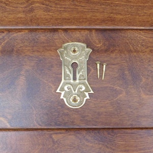 1018PB Polished Brass Key Escutcheon. 3 1/8&quot; x 1 3/4&quot; wide