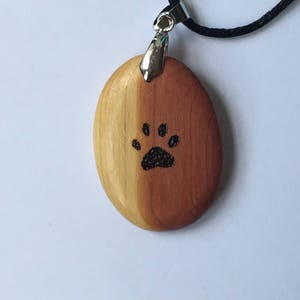 Two Tone Cedar Oval Pendant With Paw Print Graphic.  Great Dog Memorial Gift.  Free Engraving.