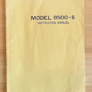 May include: A yellow instruction manual for a Model 8500-S.