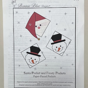 May include: A paper pattern sheet titled "Santa Pocket and Frosty Pockets" by Bonnie Blue Designs. The sheet features illustrations of Santa and snowman faces within diamond shapes, with snowflakes. The text includes instructions for paper-pieced pockets.