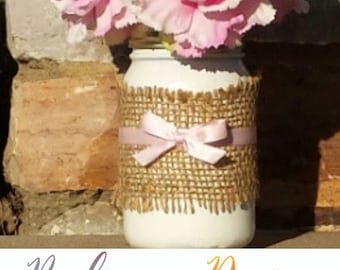 Dorothy:9 in White Mason Jar wrapped with Burlap and 3/8 pink satin ribbon inside mason jar are 3 pink carnations (Flowers are included)