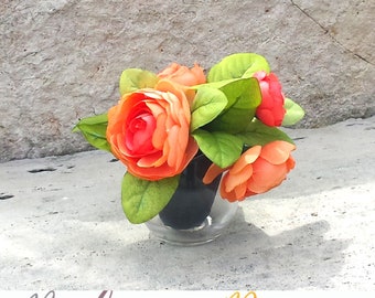 Kaylia; 6 in Orange Peony's in a small clear glass  vase. (Flowers are included)(Silk Flowers)