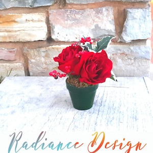 Harmony:  7  Red Poinsettia flower with in a green vase. (Silk Flowers)