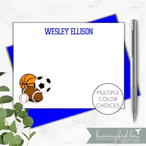 May include: White stationery card with blue text that reads "WESLEY ELLISON". The card features a graphic of a basketball, football, soccer ball, and baseball. The card also has a circle with the text "MULTIPLE COLOR CHOICES".