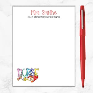 May include: White notepad with red text that says "Mrs. Smithe Davis Elementary School Nurse". The bottom of the notepad has a colorful illustration of the word "NURSE" with medical symbols.