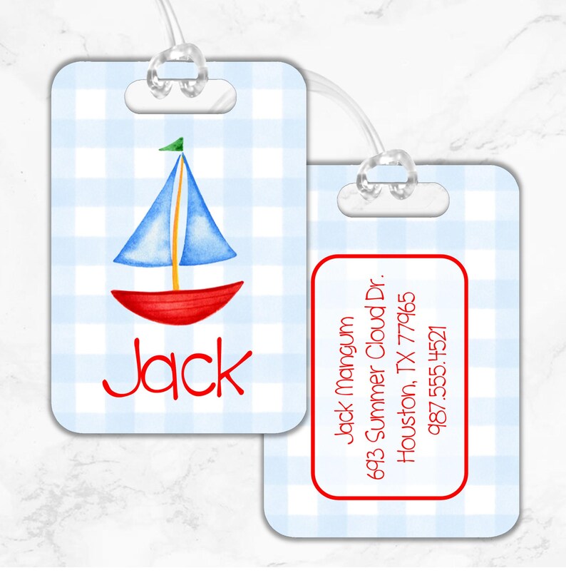 May include: Blue and white gingham luggage tag with a red and blue sailboat illustration. The tag has a clear plastic loop for attaching to luggage. The text "Jack" is printed in red on the tag. The back of the tag has a red border and the text "Jack mangum 693 Summer Cloud Dr. Houston, TX 77965 987.555.4521" is printed in red.